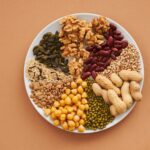 Top view of nuts, beans, and seeds on a plate, ideal for healthy dining themes.